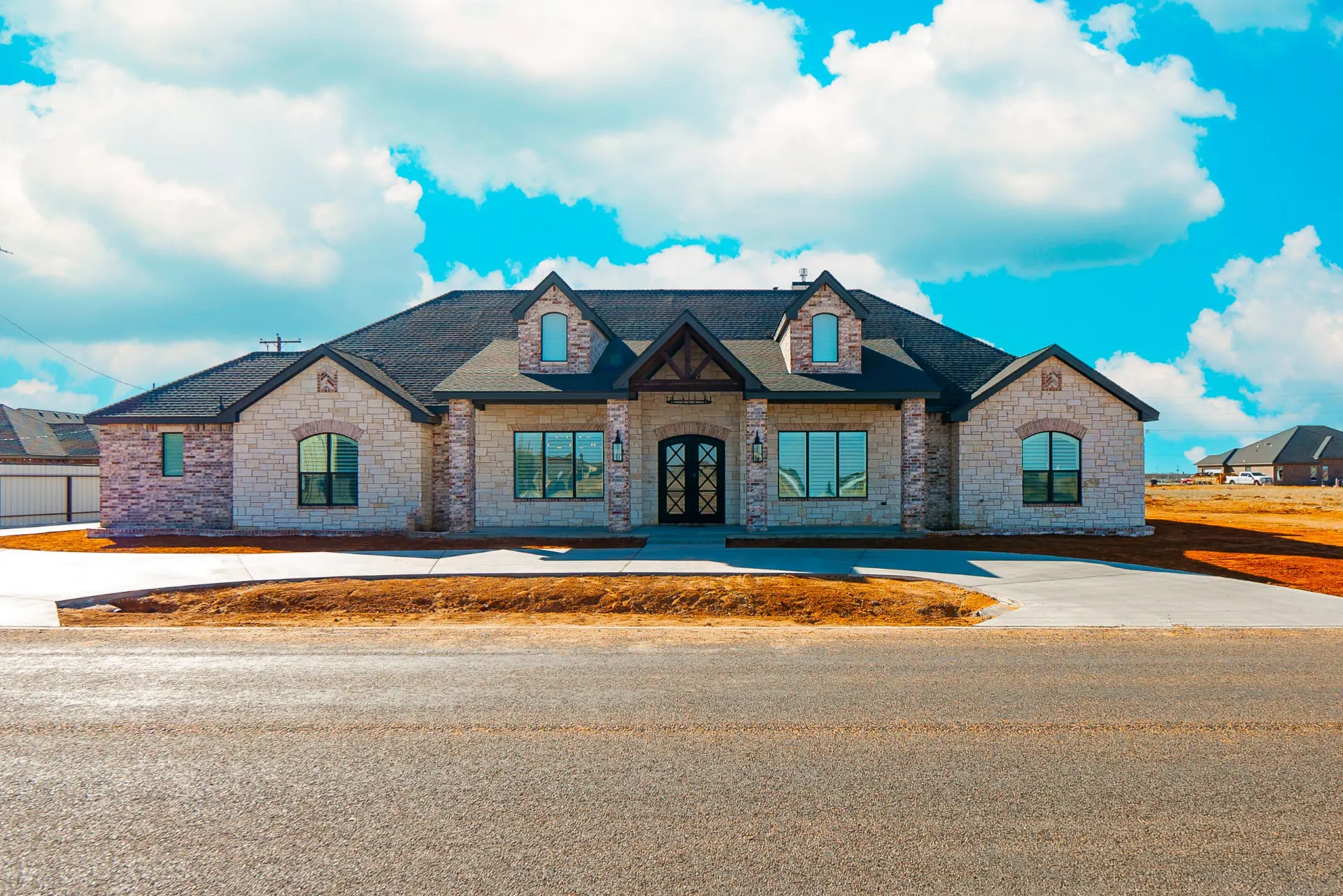 Stone-and-brick front elevation with iron double doors and timber gable at 1501 NW 12th St